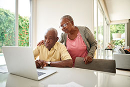 Photo of a couple researching about estate planning. Link to Life Stage Gift Planner Over Age 70 Situations.