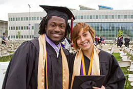 Photo of two graduates. Link to What to Give.