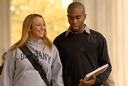 Photo of two students walking and talking. Link to Gifts by Estate Note.