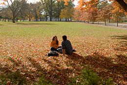 Two students sitting on the ground. Links to Beneficiary Designations Two students sitting on the ground. Links to Beneficiary Designations